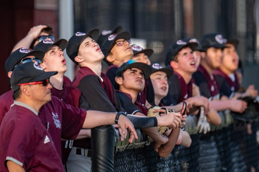 Junior Sasha Duda and others look up at a fly ball in the U-High Varsity baseball teams loss against Latin School of Chicago on April 11.