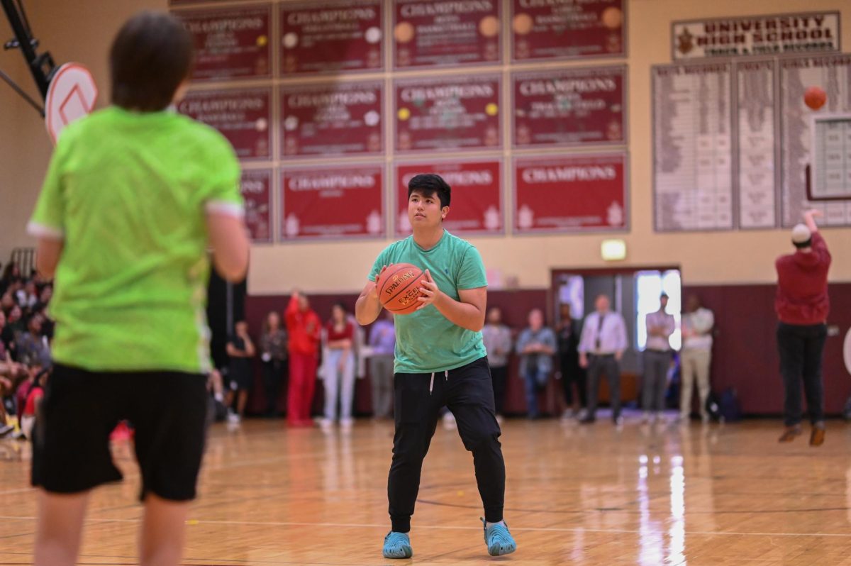Sophomore Darius Esmailzadeh prepares to air out a basketball during the three-point shooting contest. Representing the Class of 2024, Darius was the key agent in their victory.