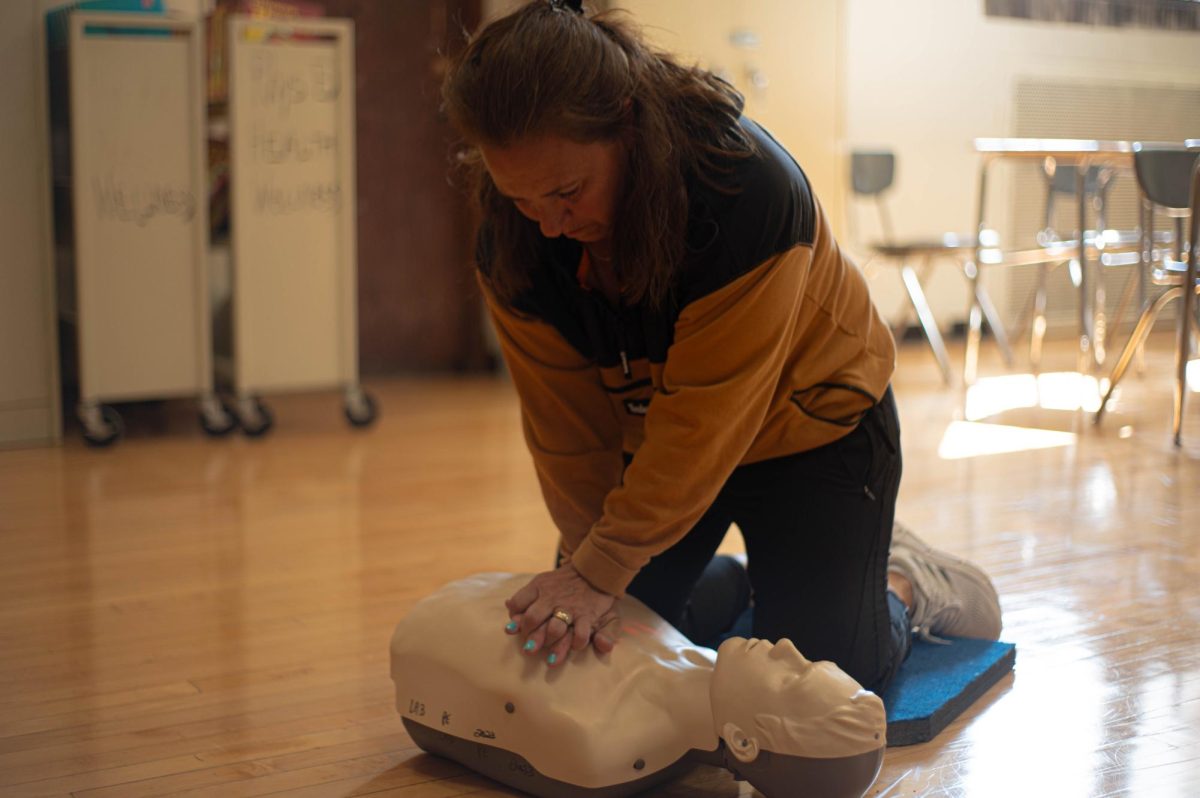 P.E.+teacher+Joyce+Grotthuss+performs+compressions+on+one+of+Labs+new+CPR+mannequins.