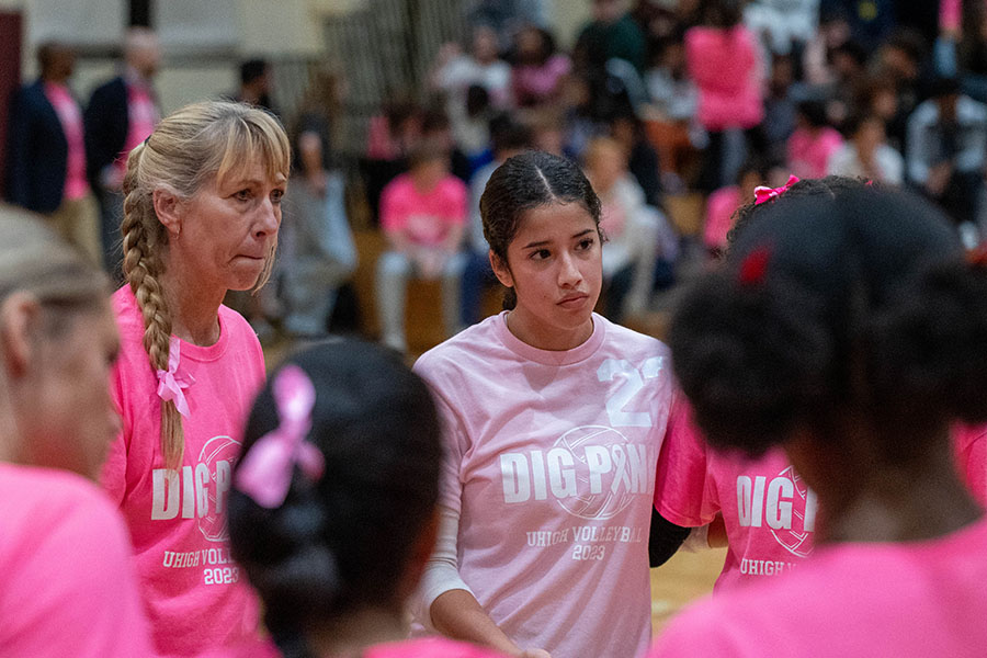 Head coach Lisa Kirchhoff and senior captain Santana Romero attentively listen to a comment during a team huddle at the Dig Pink game.