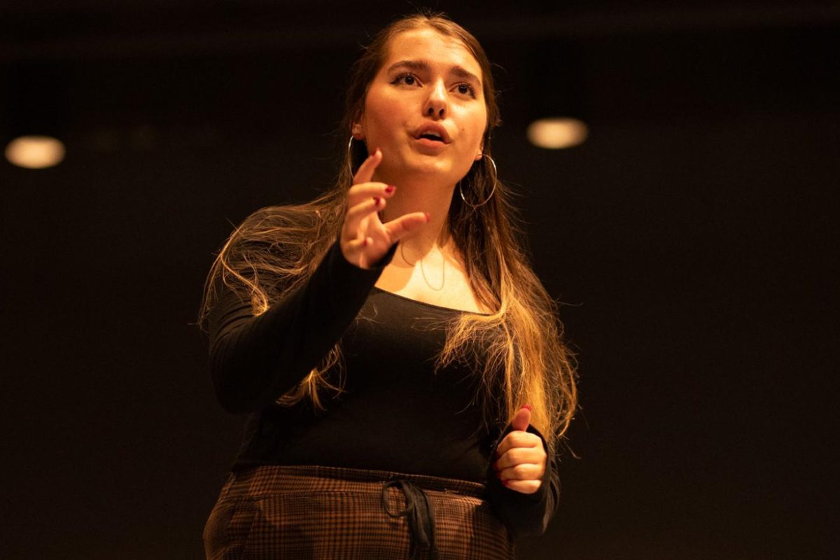 BALANCING ABILITY. Playing the stage manager in “Our Town,” senior Emma Ciesla balances multiple roles — main character, and props and makeup master. The ability to juggle these tasks stems from Emma’s love of theater.