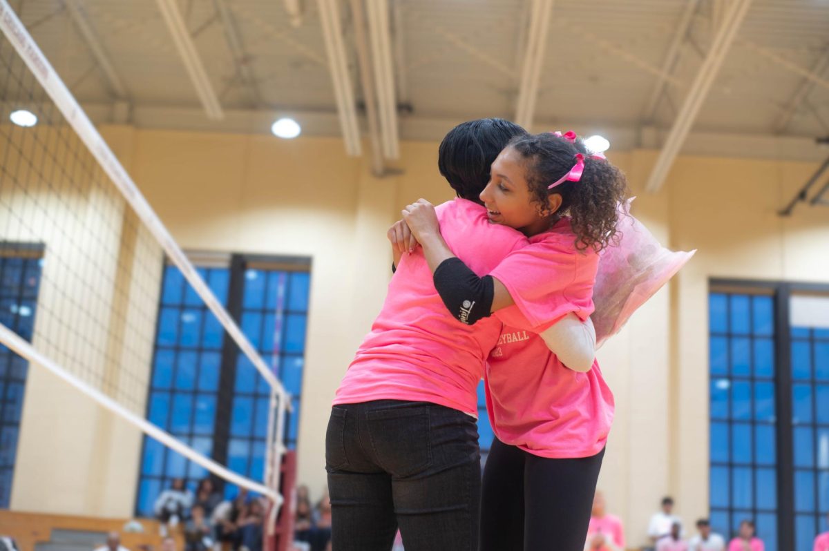 Varsity player Zora Peek Taylor, a ninth grader, embraces her mother, Monica Peek, who was the guest speaker at the Dig Pink game.