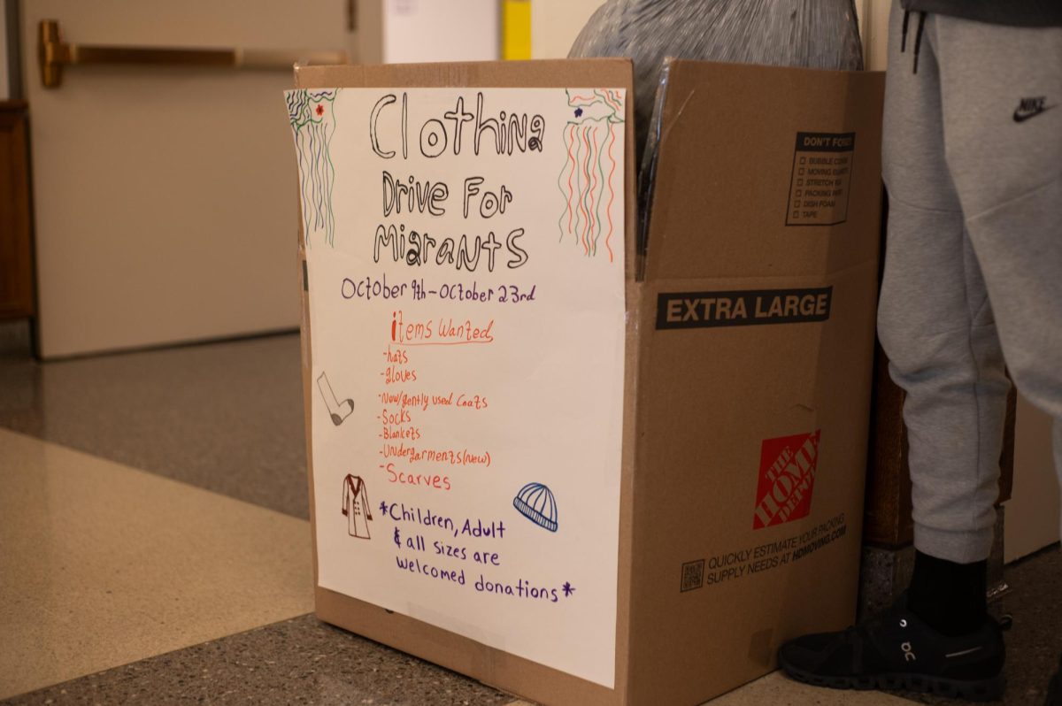 Latinos Unidos is running a clothing drive to support migrants who have recently arrived in Chicago. The donation box is located in the high school lobby.