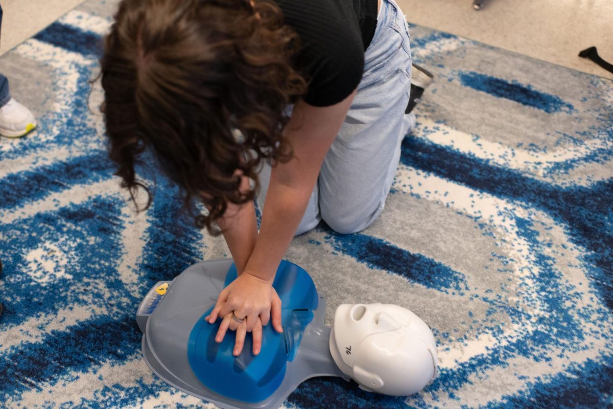A student performs CPR on a mannequin during a Heartbeat Club meeting. The Heartbeat Club will prepare students to handle real-life emergencies. 

