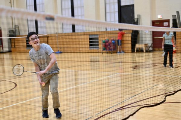 A student swings a racket in Badminton Club, meeting weekly Wednesday in Upper Kovler Gymnasium at lunch.

