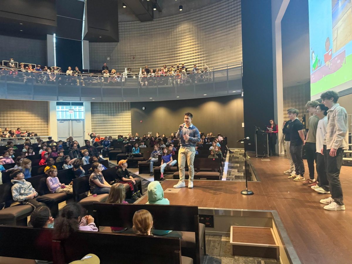 Fitness Club leader Carter Chang addresses the crowd of lower school students at a Dec. 6 joint assembly with the Kids Allergy Network. The assembly was held to spread awareness of food insecurity and their efforts to combat it.