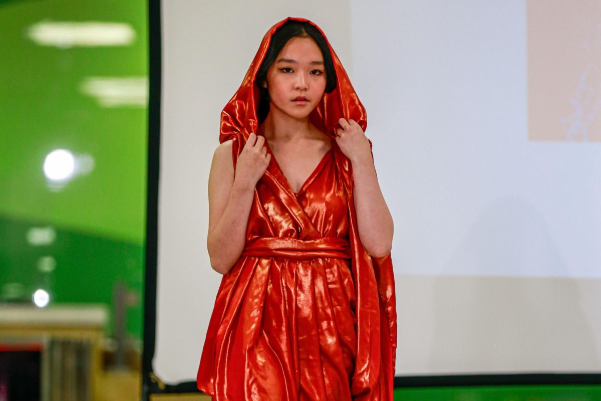 Junior Lyra Luu walks the runway at Asian Fashion show. Lyra began her modeling journey two years ago. Along with modeling, her academic and extracurricular pursuits intersect with a passion for artistic expression.