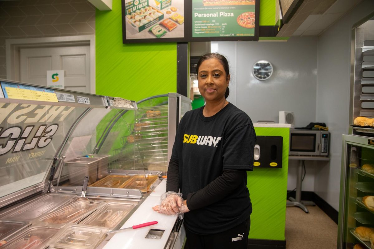 SPREADING SMILES. Sajal Patel, owner of the Subway on 59th Street, is always eager to put a smile on new and returning customers. She converses with a customer asking about their personal life while making their sandwiches, bringing a smile on their face.