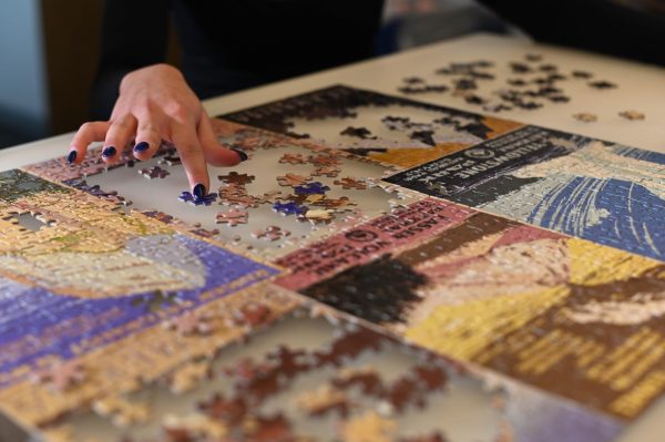 A student works on one of the many puzzles in the high school library, which offer an opportunity for students and faculty to take a break from work and engage in a fun, hands-on activity. 