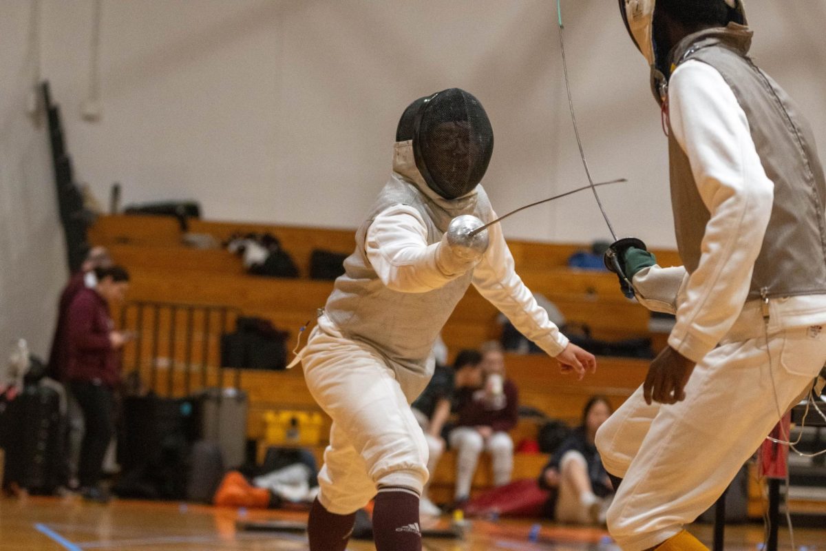Lunging at his opponent using his foil to aim for his target, sophomore Ray Han plays through a fencing match at Marian Catholic High School on Nov. 18. The fencing team ended the season with a first-place finish at the Great Lakes Conference Team Championships on Feb. 3.
