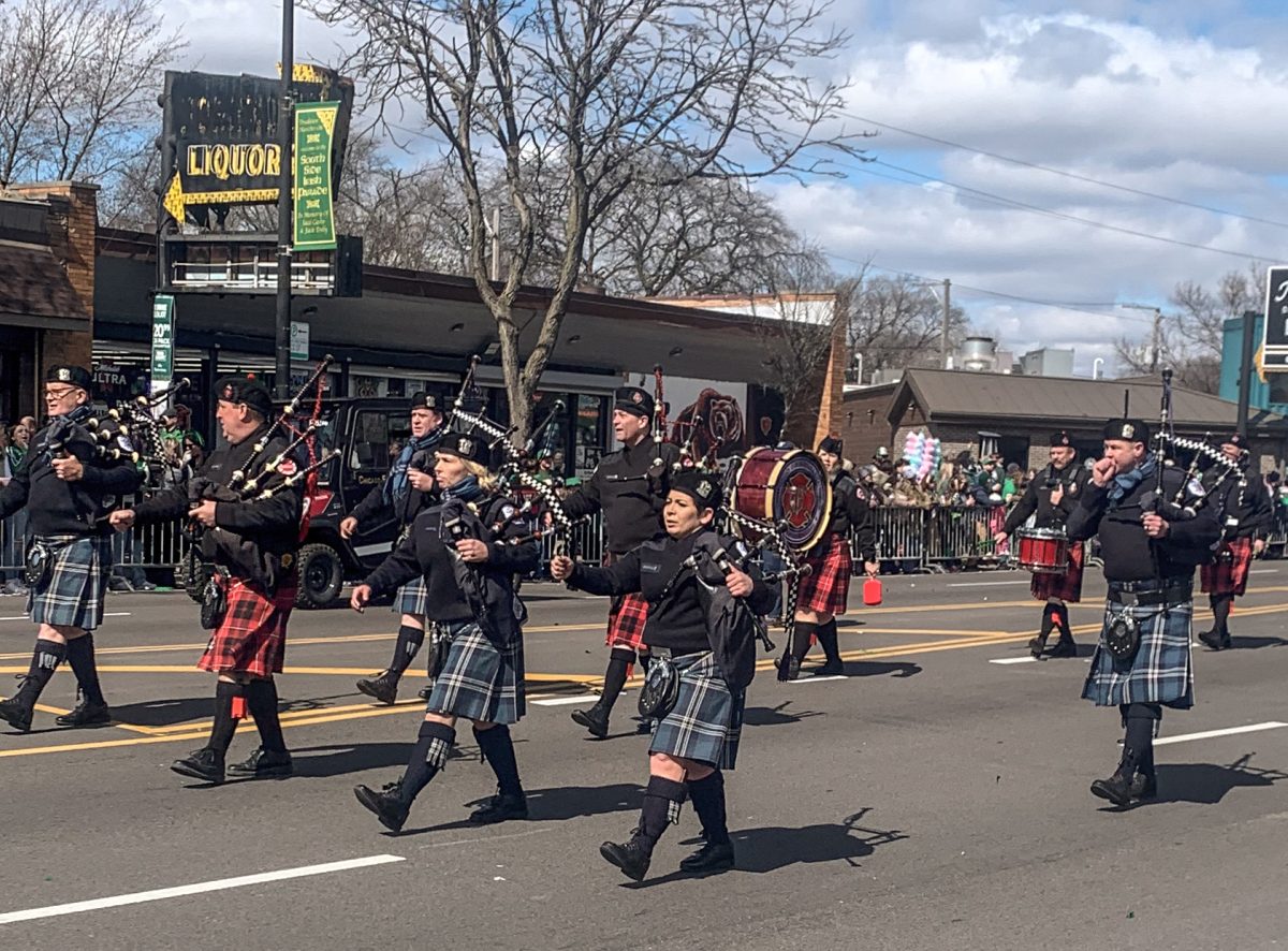 A group marches through Western Avenue for the Chicago South Side Irish Parade while playing traditional Irish music. This parade is known for celebrating Irish heritage on St. Patrick’s Day, March 17. 