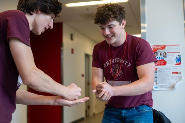 Seniors Luca Todorov and Adam Syverson play a game of Rock, Paper, Scissors to win each others bead necklaces in the grade-wide contest.