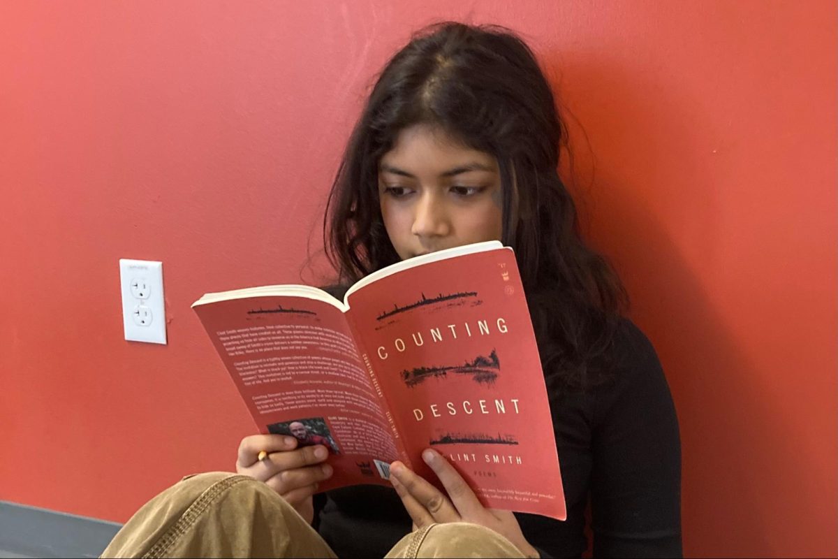 FOCUSED+EYES.+Pencil+ready%2C+ninth+grader+Saanika+Dutta+reads+the+poetry+collection+%E2%80%9CCounting+Descent%E2%80%9D+for+her+English+1+class.+The+book+is+one+of+the+changes+made+by+the+English+department+to+showcase+underrepresented+voices+in+literature.+%E2%80%9CI+think+our+English+curriculum+so+far+has+done+a+good+job+of+diversifying+the+books+we%E2%80%99ve+read%2C%E2%80%9D+Saanika+said.%0A