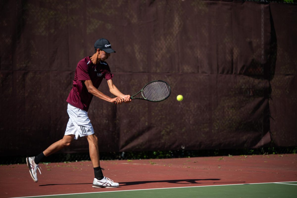 Junior Krish Khanna hits the tennis ball in his match against Latin School of Chicago on May 8.