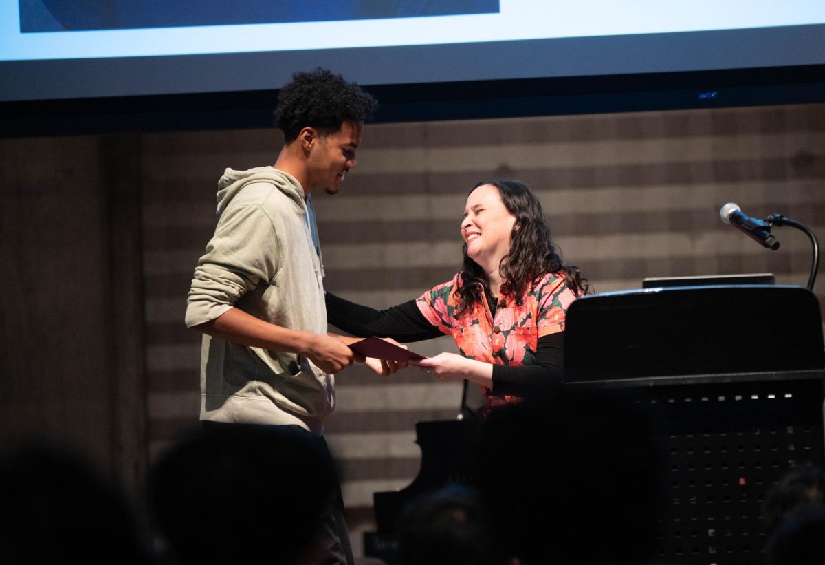 Junior Joshua Carter receives a Citizenship Award from assistant principal Zilkia Rivera-Vazquez during the Student Awards Assembly in Griffin Auditorium on May 30.