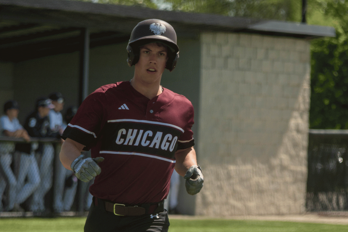 At+a+May+11+away+game+against+Chicago+Christian+High+School%2C+senior+Connor+Booth+scores+a+run.+The+varsity+baseball+team+concluded+their+season+May+22+with+a+8-9+loss+in+the+sectional+semi-final+game.+