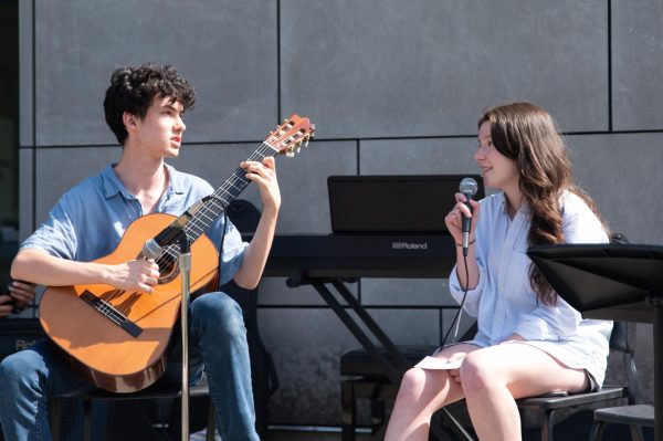 Ninth graders Isaac Sutherland and Priya Yamada perform a rendition of “Here Comes the Sun by the Beatles at Labstock, which took place May 31 afterschool on Scammon Garden.