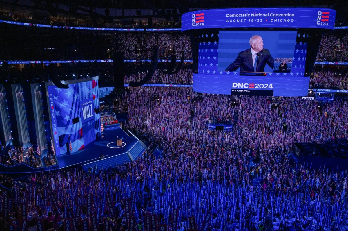 From the podium, Minnesota Gov. Tim Walz overlooks a sea of “Coach Walz” signs. The Harris-Walz campaign has embraced this nickname, drawing on his past as a high school football coach with small-town roots.