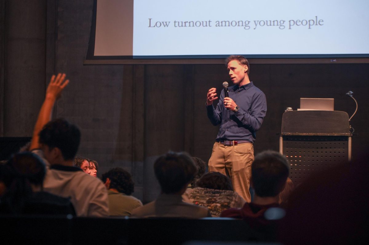 Dr. Anthony Fowler, a political science professor at the University of Chicago, takes questions from students during an  Oct. 24 assembly on political extremism and moderate candidates.