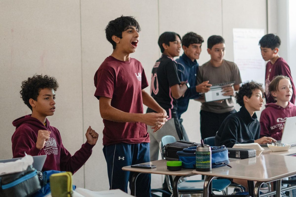 Ninth grader Shivan Shachdev reacts to a game during a Finance Club meeting. While some clubs are not experiencing major challenges, others are facing difficulties maintaining attendance.