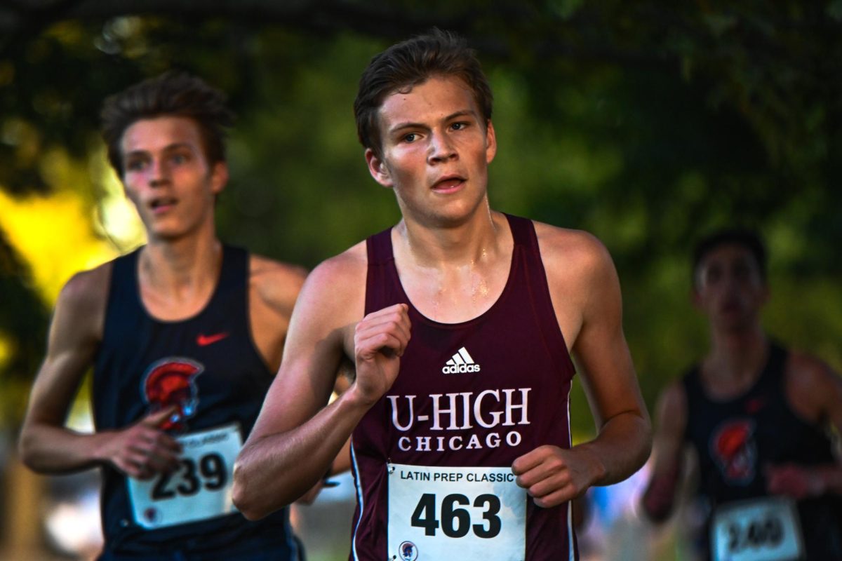 FINISHING FIRST. Racing toward the finish line, senior Simon Lane leads the pack on his way to first place at the Lincoln Park Latin Prep Invitational on Sept. 25. "It felt really good to get the win," Simon said. "It was the fastest time in a long time, so I felt very good about that." Simon qualified for the state meet Nov. 9. 