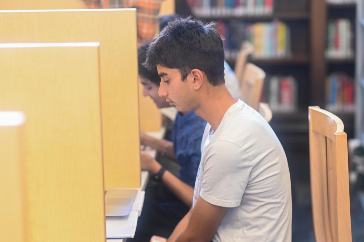 Junior Danyal Shah works in the library during Lab C Oct. 23. To promote a focused environment, librarians are now closing the GPAH doors, requiring students to check in when entering the library and controlling volume during lab periods. 