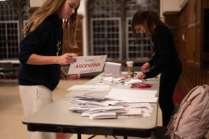 Ninth grader Sofia Caldentey and junior Maggie Yagan work together to set up C-116 to host the UNHRC committee for U-High’s Model UN conference, LabMUNC, on Friday afternoon, Dec. 6. 