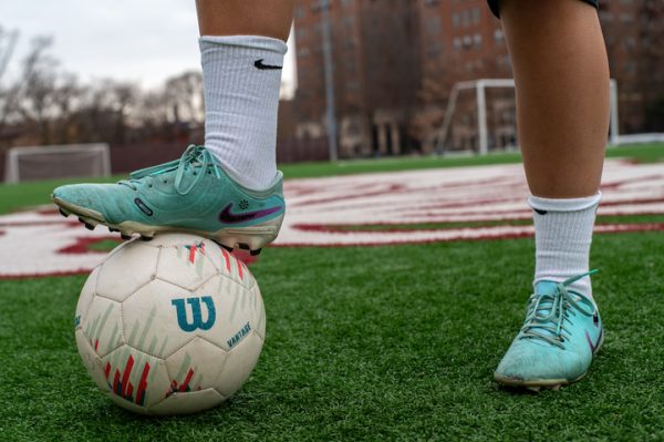 Junior Devyn Moubayed, a varsity
girls soccer player, displays her vibrant turquoise Nike Tiempo soccer
cleats as she stands on Jackman Field.