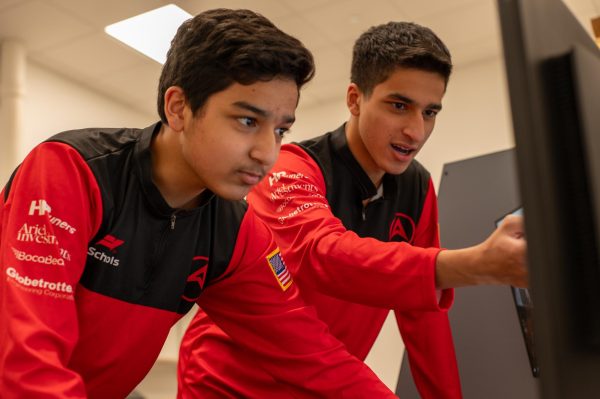 Ninth grader Zain Zaidi and senior Raza Zaidi finalize the design for the Aeros Racing pit display in advance of the Formula 1 in Schools world finals in Saudi Arabia. The team placed 13th overall with the 10th fastest car in the competition Nov. 21-26.