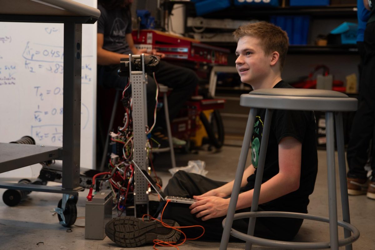 Junior James Hubbard builds a robot during a Cache Money practice session.  Especially during the competition season, when these sessions are long and frequent, the robotics team receives critical support from a committee of dedicated parents.