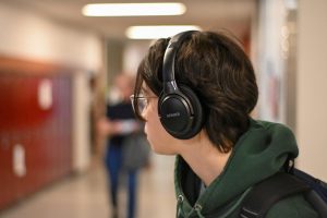 Headphone use has become a regular sight during passing periods when many students reach for them the moment class ends, creating a personal retreat in their music.