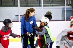 Senior Brianna Chang interacts with 
kids at the Chicago Youth Foundation, a nonprofit making ice sports accessible with free ice time, lessons, and gear for underserved kids.