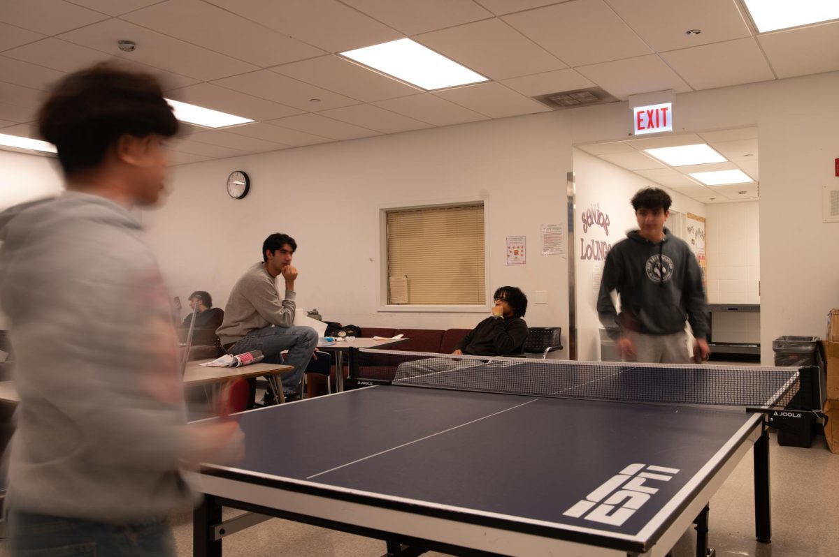 Seniors Mateo Nacu and Antonio Del Campo battle it out in a ping pong game as other students relax in the senior lounge. The lounge was temporarily closed from Nov. 19 to Dec. 2 after a lockdown drill during which seniors disrupted the space.