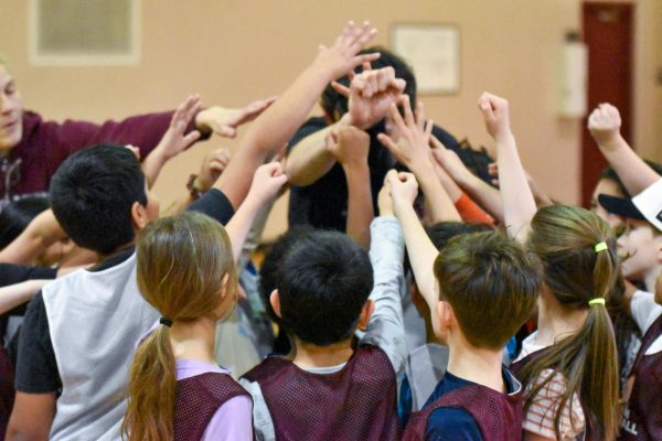 Following the first official practice of the lower school sports program, students huddle up in Lower Kovler to celebrate their hard work.