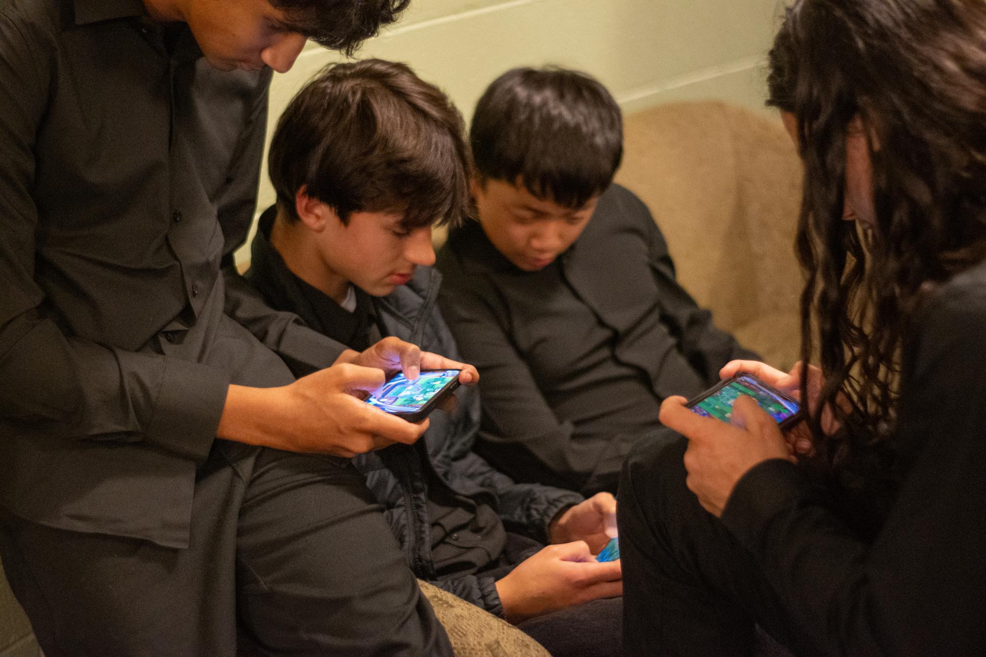 A group of freshmen gather to play   Brawl Stars during a high school concert at Mandel Hall. The online game has grown increasingly popular at U-High and serves as a way for students to connect with one another. 