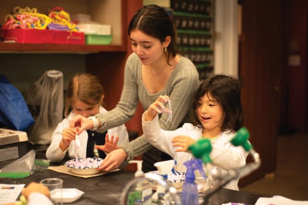 Senior Brianna Chang makes slime as an experiment with Lab first graders as part of the Beaker Buddies program, which will not run next school year.