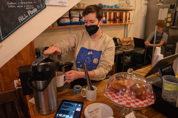 University of Chicago graduate Hannah Nyhart, the co-owner and co-founder of Build Coffee coffee shop and used bookstore, works behind the counter. Despite years of experience running Build Coffee and getting to know the community, Ms. Nyhart has decided to sell the shop.