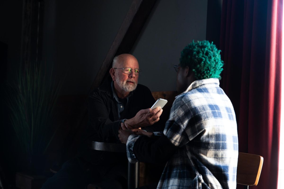 Photographer and documentarian Marc Monaghan interviews Levi, a student at Dyett High School, before his performance at The Promontory as part of the Intonation Music’s Student Showcase on Dec. 21. Although Mr. Monaghan had an interest in photography from a young age, the Hyde Park Herald journalist didn’t pursue it as a career until his 50s.