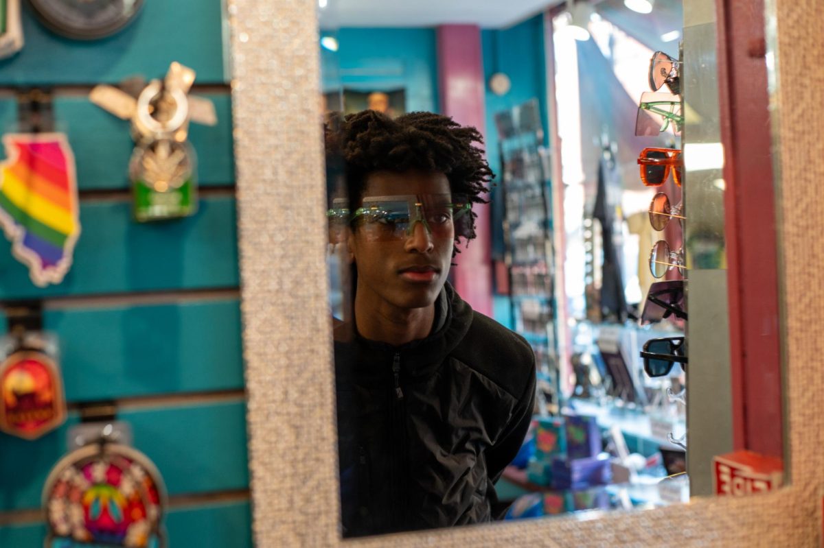 Noah Runesha tries on a pair of sunglasses while shopping in Galena’s historic downtown Jan. 31.
