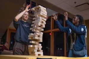 Before returning to their townhomes for the night on Jan. 31, Stefanie Giurcanu and Olivia Adams play Jenga in the basement of the Eagle Ridge Resort main lodge.