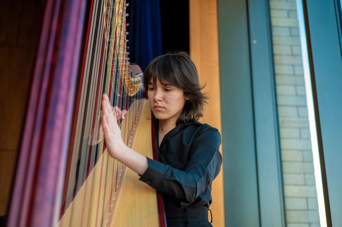 Senior Sierra Stacy strums at her harp, locked in concentration. Harpists at U-High have a unique and close-knit community that comes with playing this rare and technically demanding instrument. 