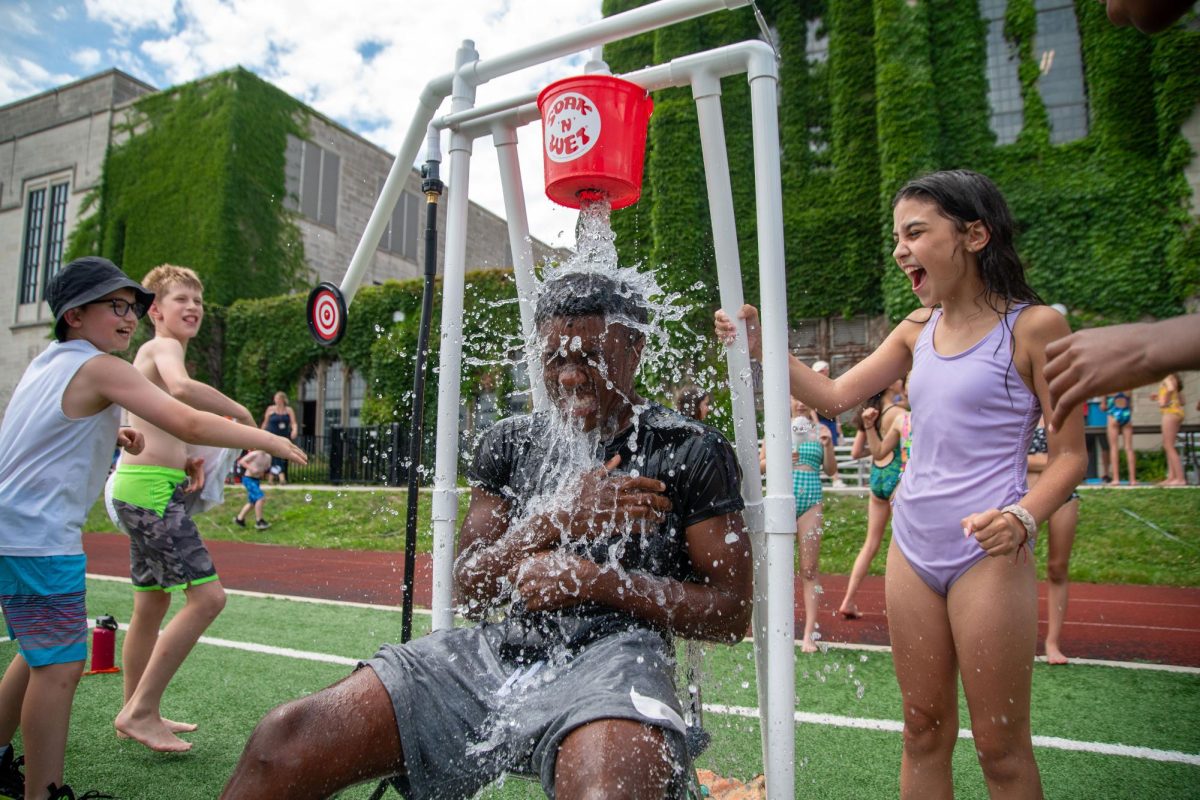 Campers drench counselor and junior Mo Iyi-Ojo using an alternative dunk tank at Summer Lab last year. The application form to be counselor for Summer Lab is open until Feb. 17 at 9 p.m.