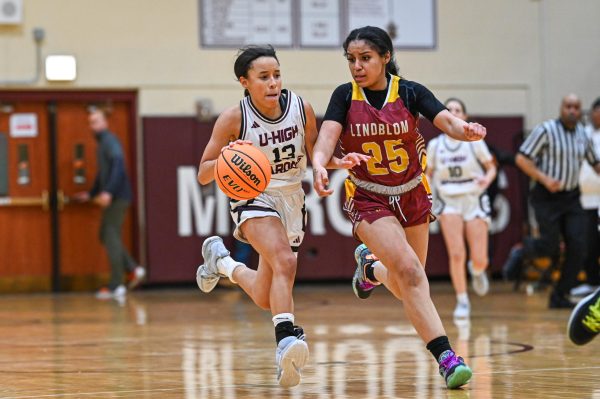 Senior Alex Giles dribbles around her defender from Lindblom High School in Upper Kovler Gymnasium on Feb. 7. 