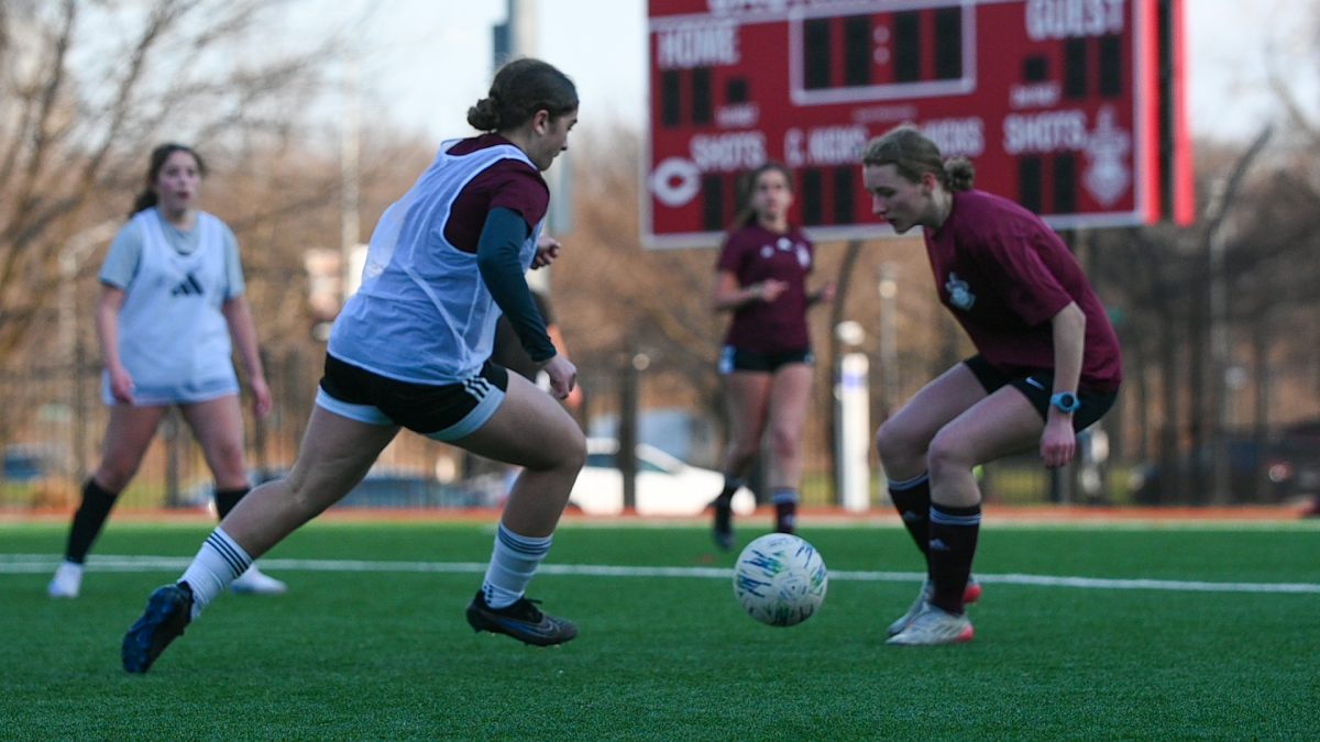 Junior Leyla Yates dribbles in the direction of senior Maya Pytel in a March 26 practice. Leyla said the varsity girls soccer team was practicing quick transitions between offense and defense. “Practice is essential for me to improve the errors in my game and to practice my strengths,” Leyla said. “During practice, we practice formations and runs in order to better understand our positions and purpose on the field.”