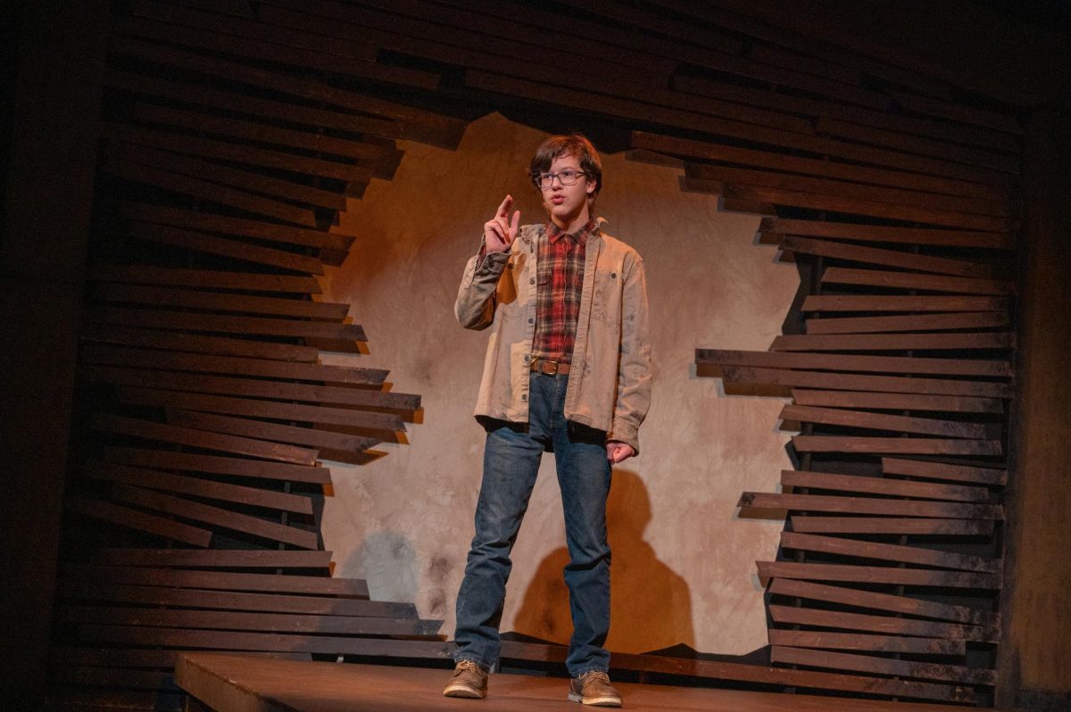 PASSIONATE FOR PROGRESS. Sophomore Felix Calageri delivers lines in the role of Gary during the dress rehearsal on Nov. 12. Felix played a social union worker, which he brought alive through putting himself in the shoes of his character to understand the character’s range of emotion. “I tried to express that line through the lens that I’m this person who cares for his community and he puts his community first, so that’s where I was trying to come from,” Felix said in reference to a specific line where Gary speaks out against the company spreading lies. 
