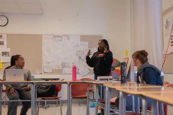In a meeting between English 1 teachers, Arney Bray stands up and addresses fellow English teachers. The Lab review was released and is currently available online. One part of the review talked about curricular autonomy and standardizing class expectations.