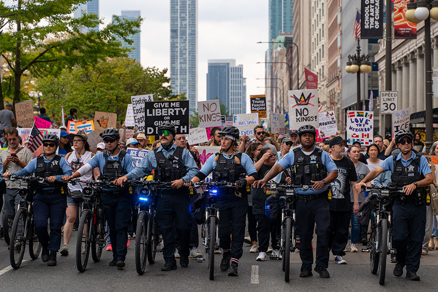 OCTOBER — Marching with Intent. Chicago police officers walk ahead of demonstrators on South Michigan Avenue during the “No Kings” protest in downtown Chicago on Oct. 18, part of a nationwide movement opposing the Trump administration in which members of the Lab community participated. 