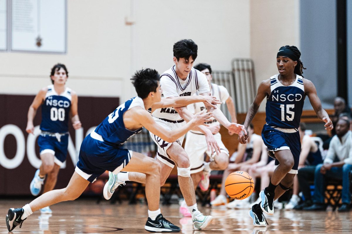 Fighting for the basketball, sophomore Xavier Fisher plays in a game against North Shore Country Day on Jan. 9 in Upper Kovler. 