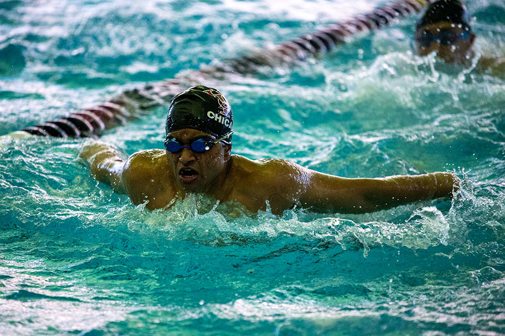 Smooth Strokes. Senior Sid Gujja performs a butterfly stroke during a warmup at a swimming meet on Jan. 28. The meet took place at the University’s Ratner Athletics Center against De La Salle, Mt. Carmel and DePaul College Prep. Photo by Elspeth LaCroix-Birdthistle