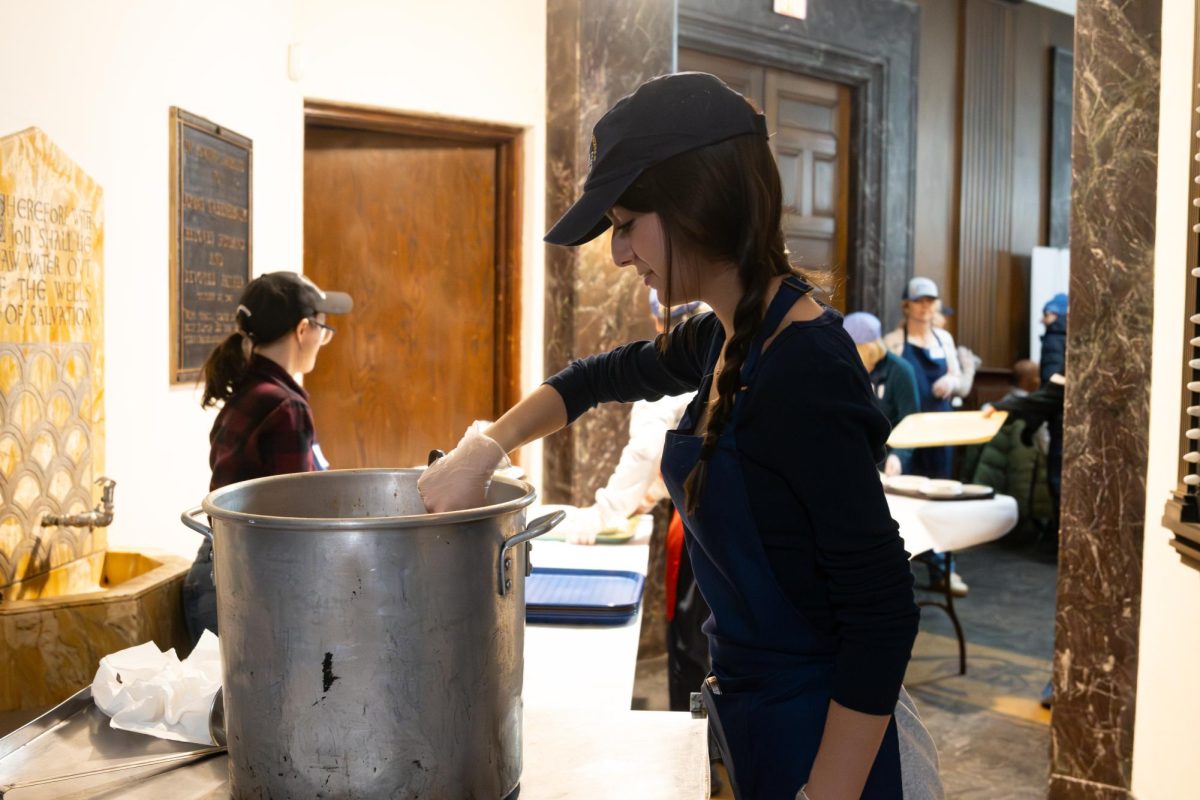 Junior Sofia Schwartz stirs a pot of food while volunteering at Temple Sholom.For Sofia and her fellow junior, Ilana Schopin, volunteering with their temple's Monday Meal Mitzvah program has connected each of them to Judaism, other volunteers and those receiving meals.
